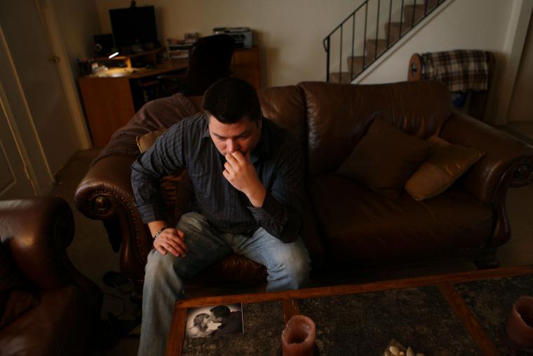 Eric Clevinger, shown on Feb. 17, 2012, in his Virginia Beach home, was recently &quot;laid off&quot; from the Navy after 14 years because of a measure to thin the ranks in overmanned job classifications. He hasn't been told why he was chosen, and is scared of what he faces in this economy. His main concern is his 7-year-old daughter's well-being and education, and being able to provide for that. Her picture is on the corner of the table in front of him.  &lt;span class='credit'&gt;(Vicki Cronis-Nohe | The Virginian-Pilot)&lt;/span&gt;